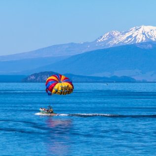 boat in lake taupo with mountain in background