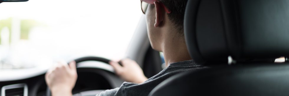 man driving car during daytime