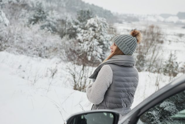 woman looking at beautiful snowy landscape
